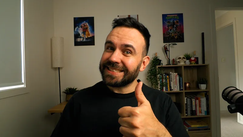Nick Gulic at his desk giving a thumbs up
